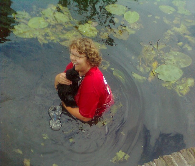 one of the volunteers saved cat Melvin from a floating island (put in the canal to prevent cats from drowning)